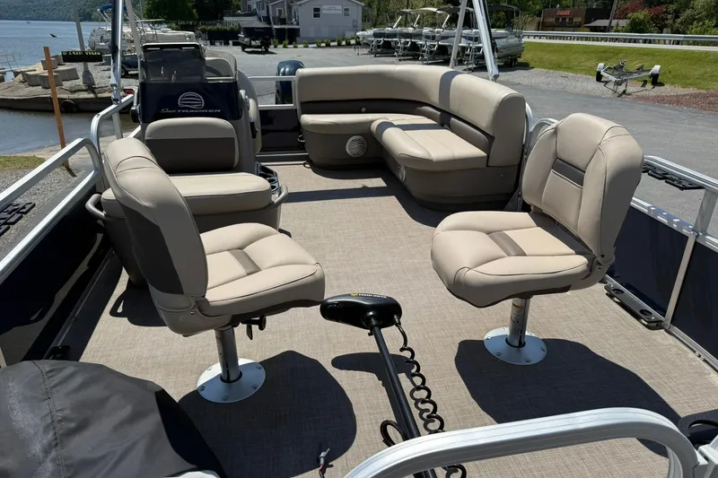 Slide: The Image of 2023 Sun Tracker Bass Buggy 16 XL Select pontoon boat interior with beige seating. - 8