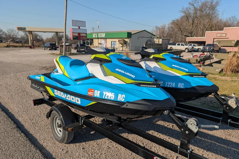 The Image of 2016 Sea-Doo GTI SE 130 jet skis on trailer in parking lot. - 0