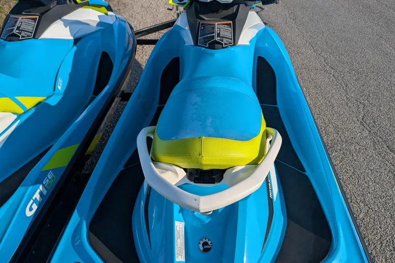 Slide: The Image of 2016 Sea-Doo GTI SE 130 jet ski, blue and yellow, parked on pavement. - 11