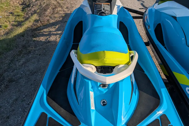 Slide: The Image of 2016 Sea-Doo GTI SE 130 jet ski, blue and yellow, parked on a trailer. - 12