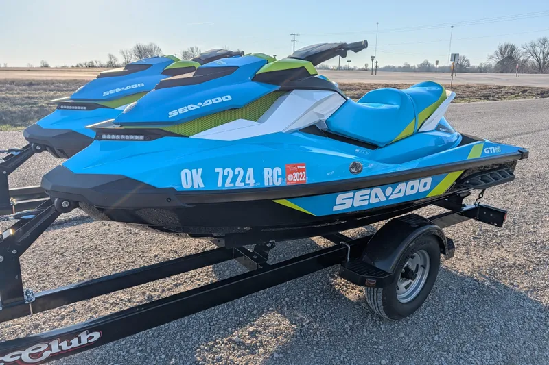 Slide: The Image of 2016 Sea-Doo GTI SE 130 jet skis on trailer, parked on gravel road. - 5