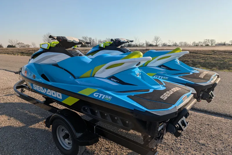 Slide: The Image of 2016 Sea-Doo GTI SE 130 jet skis on a trailer, parked on a rural road. - 7