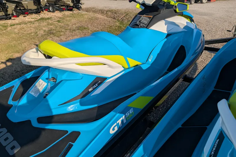 Slide: The Image of 2016 Sea-Doo GTI SE 130 jet ski in vibrant blue and yellow on display. - 9