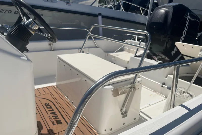 Slide: The Image of 2007 Boston Whaler 160 Dauntless boat interior with steering wheel and Mercury engine. - 4