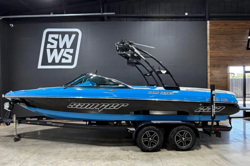 The Image of 2016 Sanger V237 S boat in showroom, blue and black design, on trailer. - 1