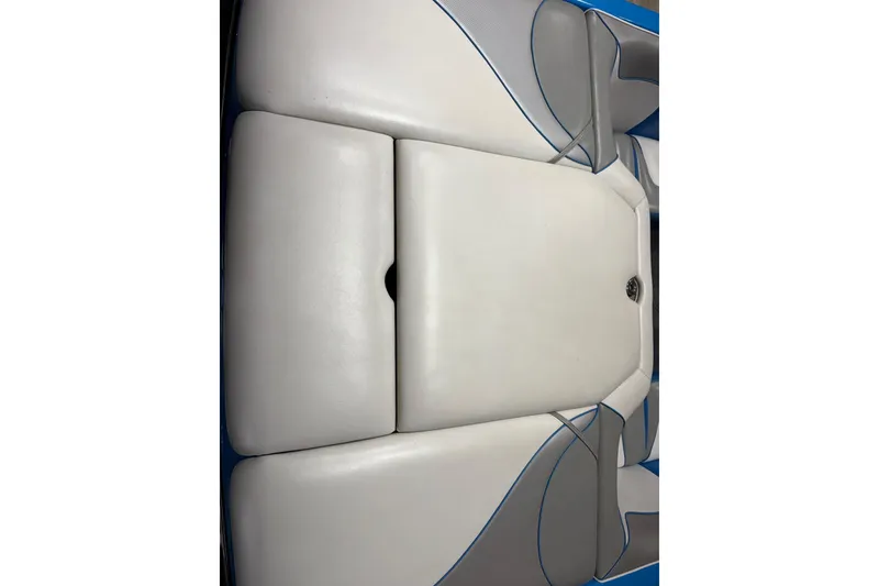 Slide: The Image of 2016 Sanger V237 S boat interior with white and gray cushioned seating. - 11
