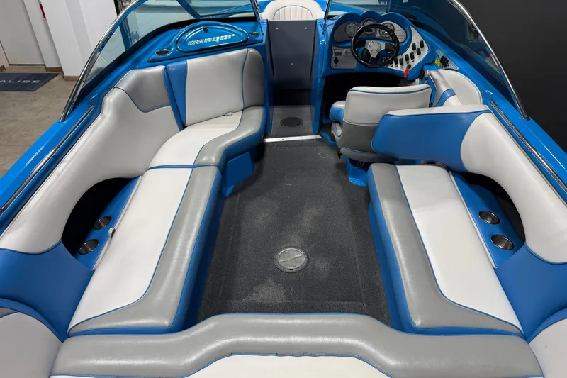 Slide: The Image of Interior of a 2016 Sanger V237 S boat with blue and white seating. - 12
