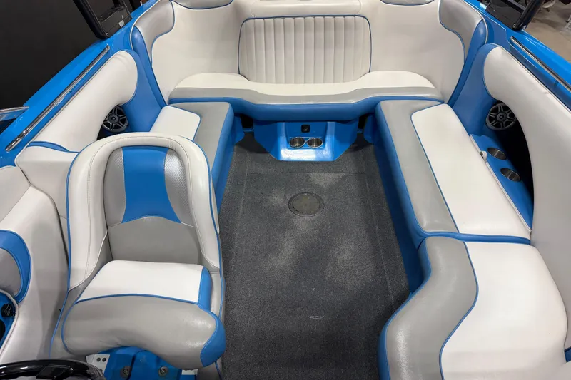 Slide: The Image of Interior of a 2016 Sanger V237 S boat with blue and white seating. - 14