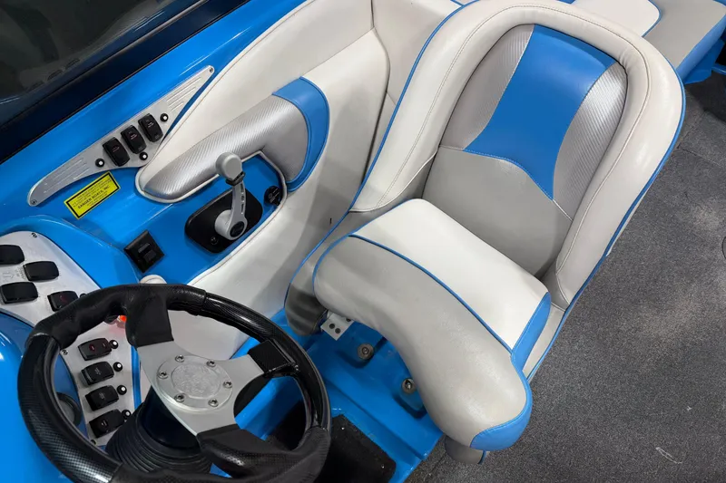 Slide: The Image of Interior of a 2016 Sanger V237 S boat with blue and white seating. - 15
