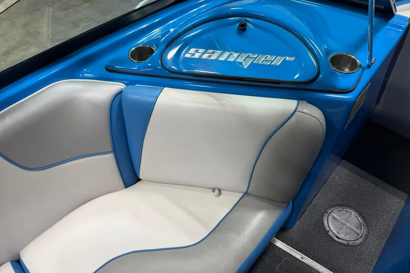 Slide: The Image of Interior of a 2016 Sanger V237 S boat with blue and white seating. - 16