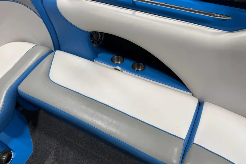 Slide: The Image of Interior of a 2016 Sanger V237 S boat with blue and white seating. - 17