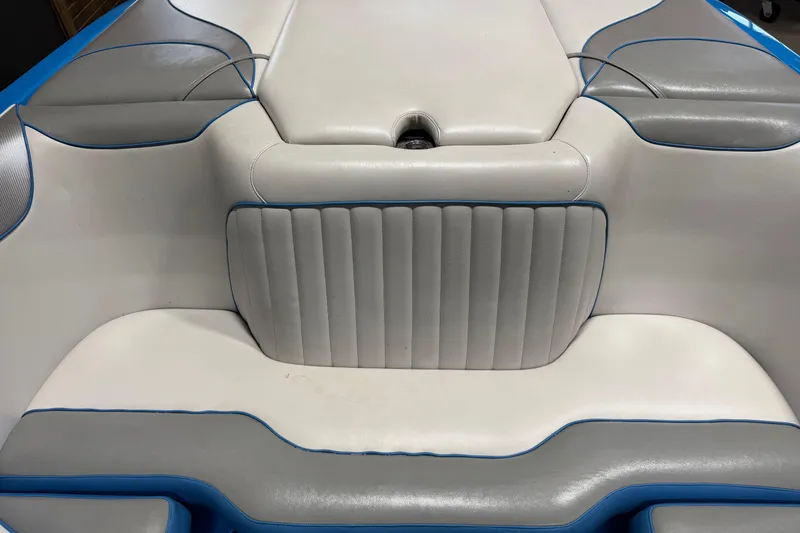 Slide: The Image of Interior seating of a 2016 Sanger V237 S boat with white and blue upholstery. - 18
