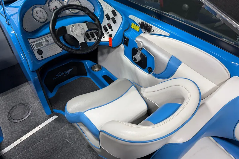 Slide: The Image of Interior of a 2016 Sanger V237 S boat with blue and white seating. - 22