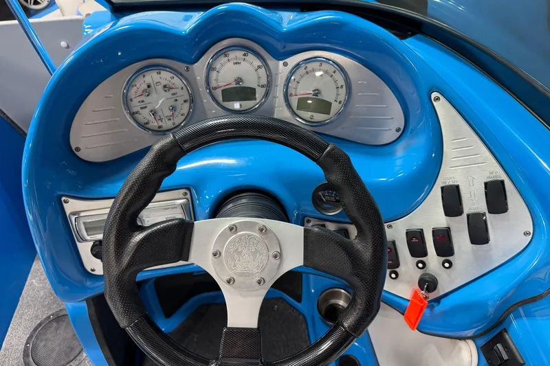 Slide: The Image of 2016 Sanger V237 S boat dashboard with steering wheel and instrument panel. - 23