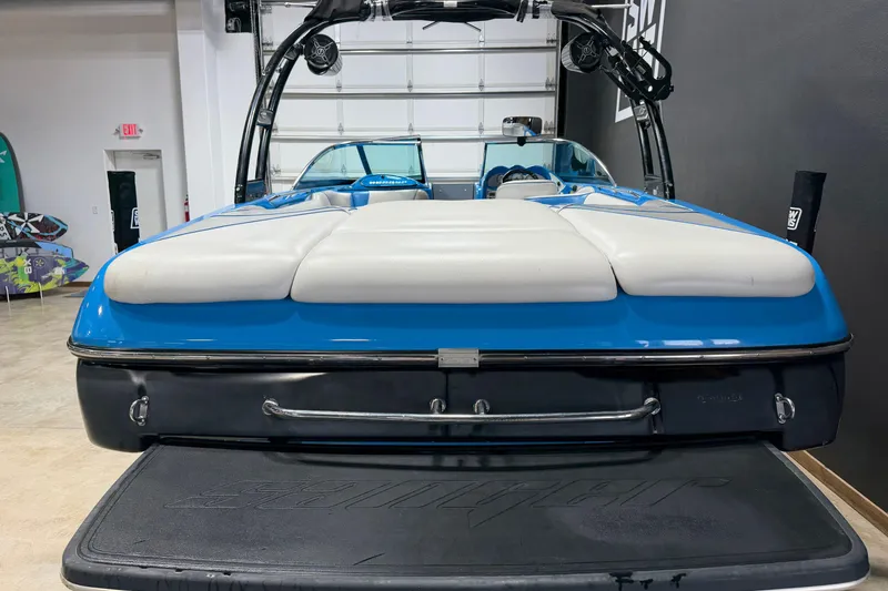 Slide: The Image of 2016 Sanger V237 S boat, blue and white, in a showroom setting. - 4