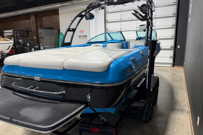 Slide: The Image of 2016 Sanger V237 S boat with blue and white upholstery in a showroom. - 5