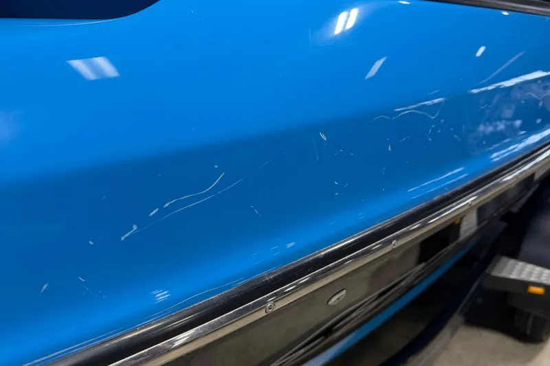 Slide: The Image of 2016 Sanger V237 S boat with blue exterior and visible scratches. - 8
