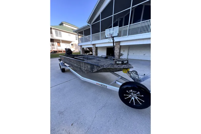 The Image of 2026 Excel 1854 Shallow Water F4 Pro Hull boat on trailer, parked in driveway. - 0