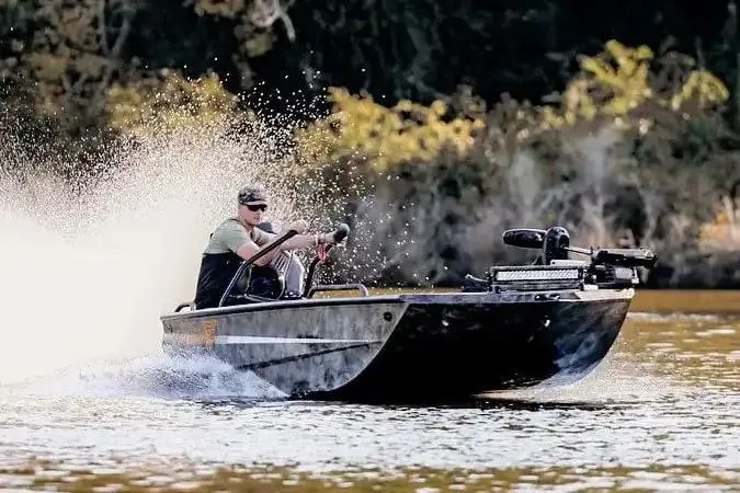 Slide: The Image of Manufacturer Provided Image: 2026 Excel 1854 Shallow Water F4 Pro Hull speeding on a river, creating a splash. - 13