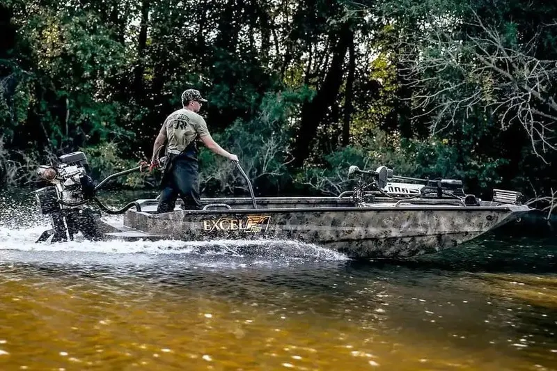 Slide: The Image of Manufacturer Provided Image: 2026 Excel 1854 Shallow Water F4 Pro Hull navigating a forested river. - 15