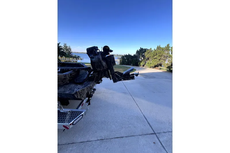 Slide: The Image of 2026 Excel 1854 Shallow Water F4 Pro Hull on trailer near waterfront. - 6