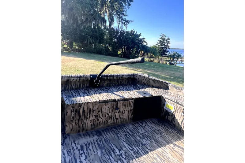 Slide: The Image of 2026 Excel 1854 Shallow Water F4 Pro Hull boat with camouflage design in scenic outdoor setting. - 7