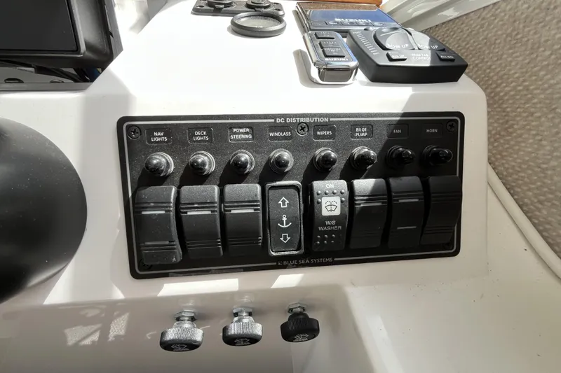 Slide: The Image of Control panel of a 2022 Sea Sport 24' Explorer boat with various switches and controls. - 11