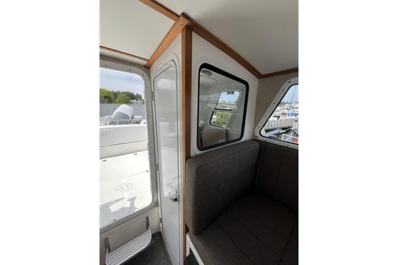 Slide: The Image of Interior view of 2022 Sea Sport 24' Explorer boat, featuring seating and windows. - 12