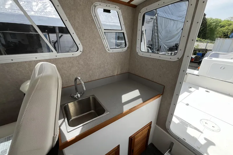 Slide: The Image of Interior of a 2022 Sea Sport 24' Explorer boat with sink and windows. - 15