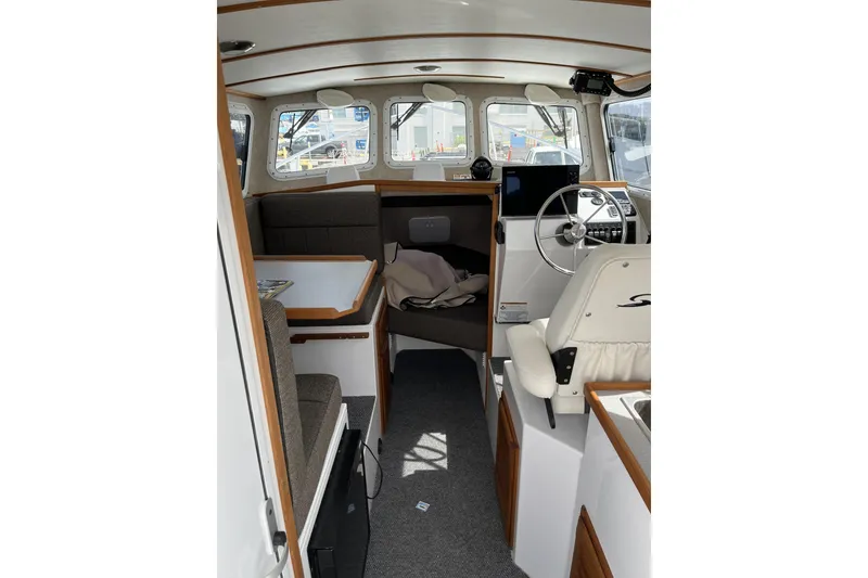 Slide: The Image of Interior of 2022 Sea Sport 24' Explorer boat, featuring seating and steering area. - 17