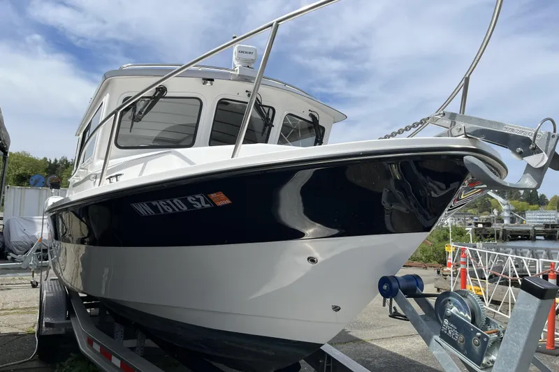 Slide: The Image of 2022 Sea Sport 24' Explorer boat on trailer, dockside view. - 2