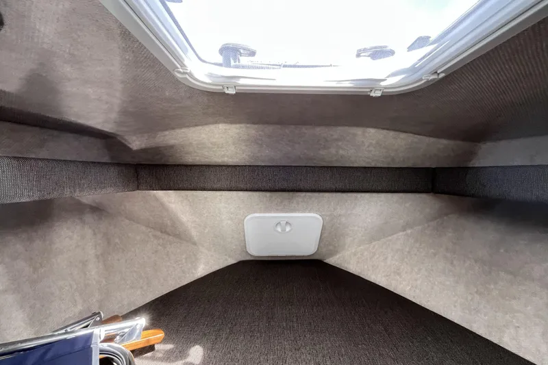 Slide: The Image of Interior cabin of 2022 Sea Sport 24' Explorer boat, featuring a skylight and compact design. - 20