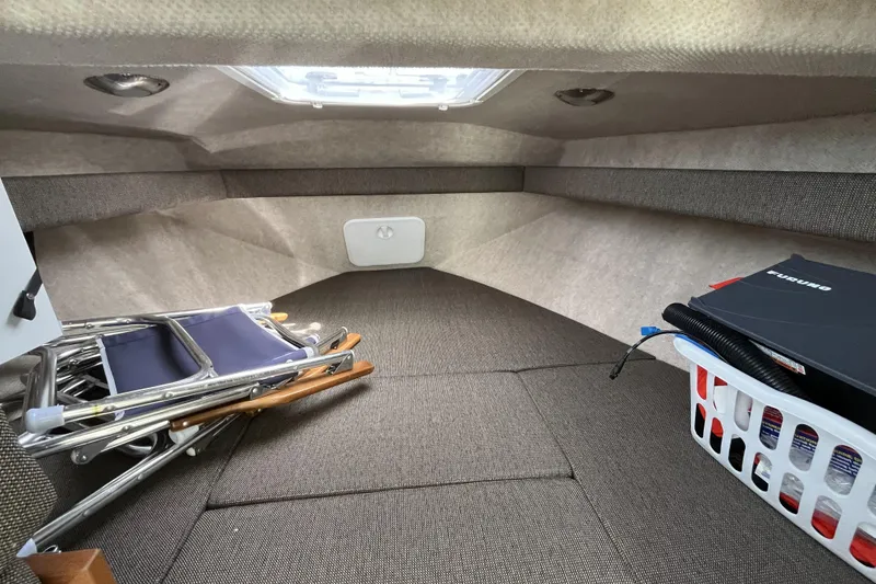 Slide: The Image of Interior cabin of 2022 Sea Sport 24' Explorer with storage items and seating. - 21