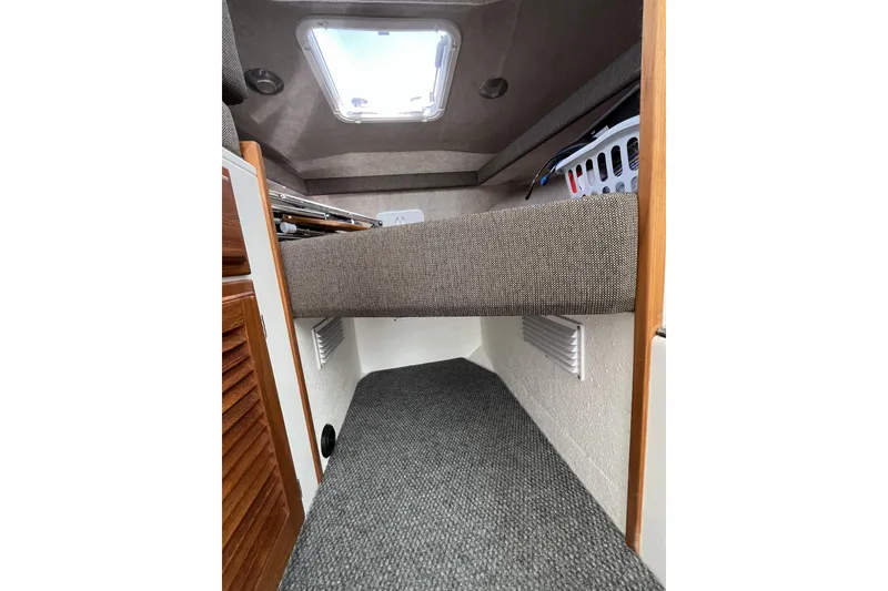 Slide: The Image of Interior cabin view of 2022 Sea Sport 24' Explorer boat, featuring cozy sleeping area. - 22