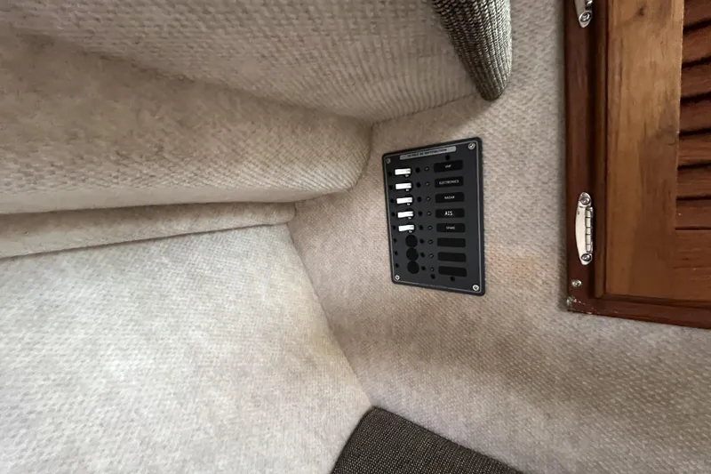 Slide: The Image of Interior view of a 2022 Sea Sport 24' Explorer boat with control panel and wooden cabinet. - 24
