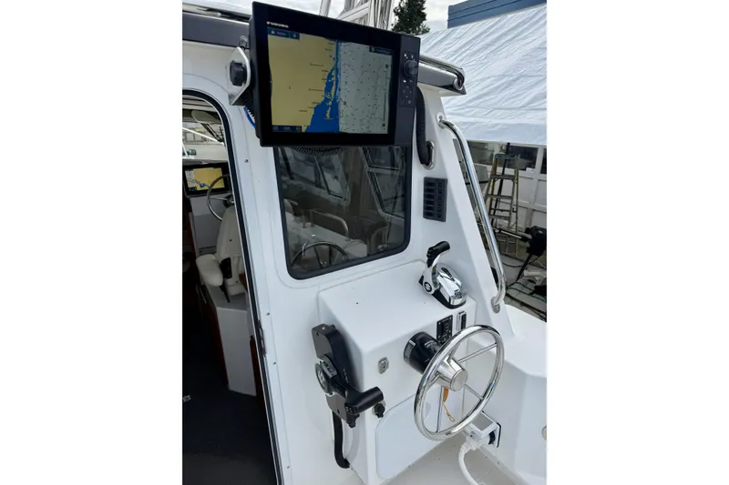 Slide: The Image of Interior helm of 2022 Sea Sport 24' Explorer boat with navigation display. - 26