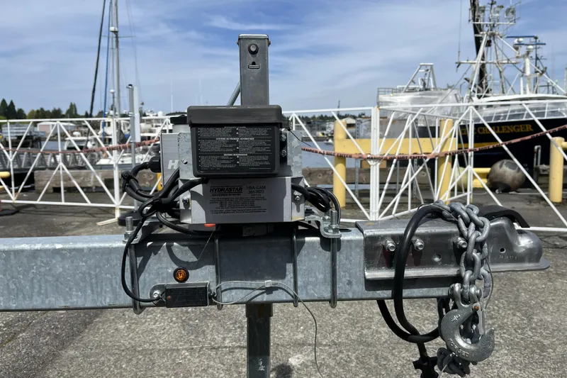 Slide: The Image of Trailer hitch with hydraulic brake actuator at a marina, Sea Sport 24' Explorer, 2022 model. - 28