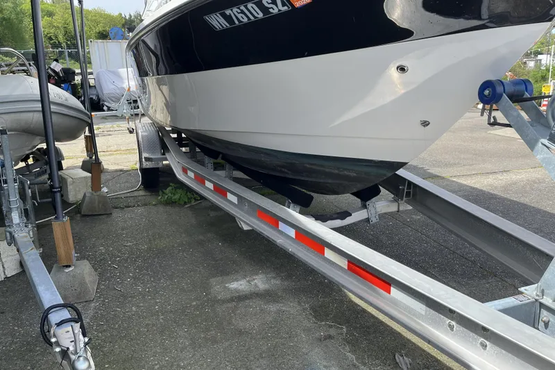 Slide: The Image of 2022 Sea Sport 24' Explorer boat on trailer, parked outdoors. - 30