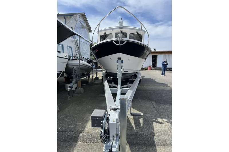 Slide: The Image of 2022 Sea Sport 24' Explorer boat on trailer, parked outdoors under a clear sky. - 4