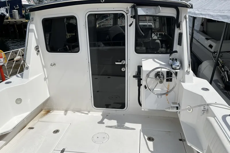 Slide: The Image of 2022 Sea Sport 24' Explorer boat cockpit with steering wheel and controls. - 5