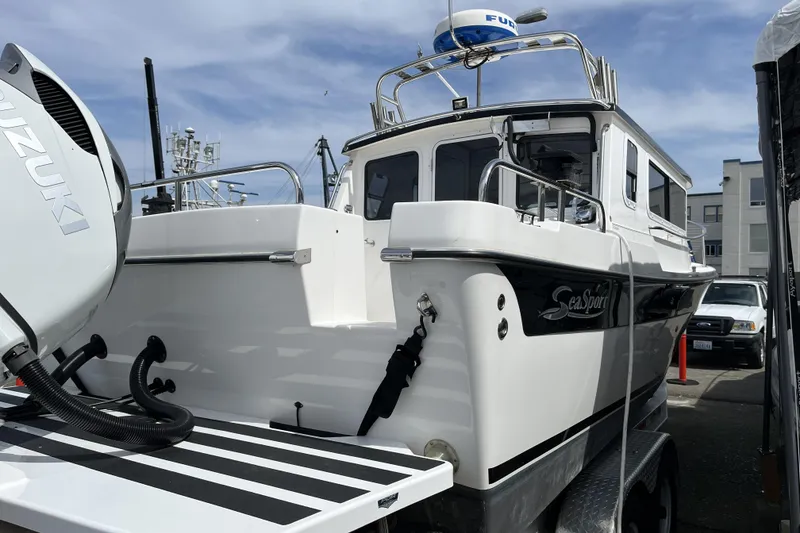 Slide: The Image of 2022 Sea Sport 24' Explorer boat with Suzuki engine, docked outdoors. - 6
