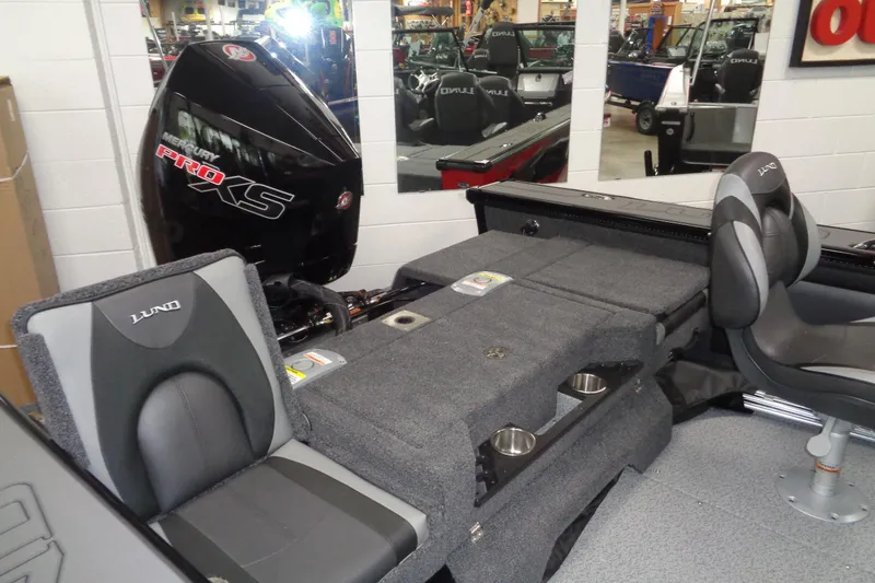 Slide: The Image of 2026 Lund 1875 Pro-V boat interior with Mercury Pro XS engine, featuring comfortable seating. - 10