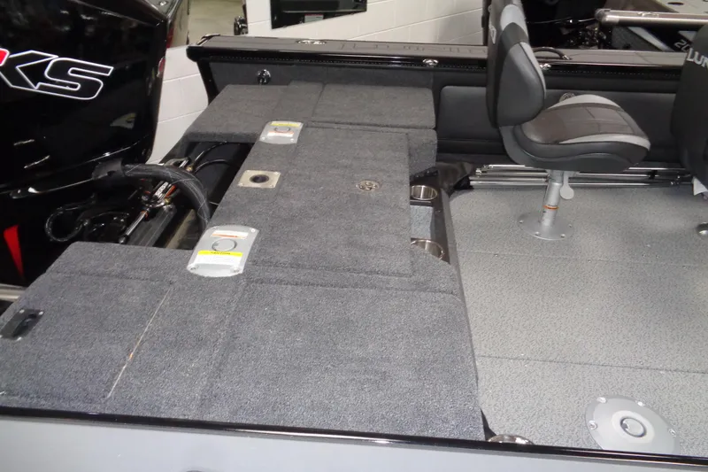 Slide: The Image of 2026 Lund 1875 Pro-V boat interior with seating and storage compartments. - 11