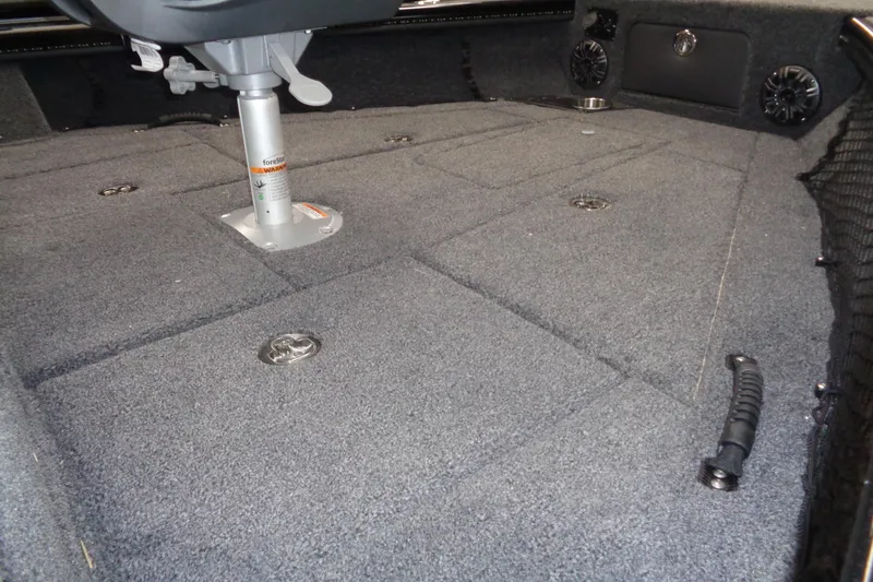Slide: The Image of 2026 Lund 1875 Pro-V boat interior with carpeted deck and seating pedestal. - 9