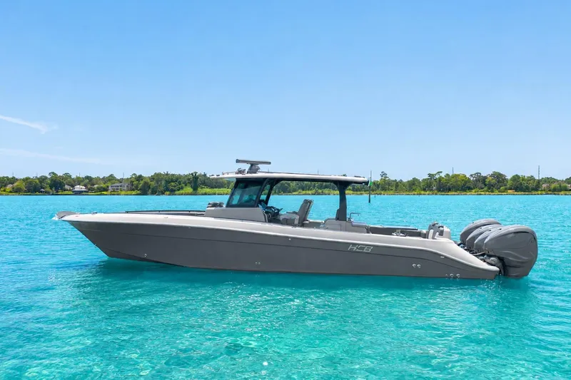 The Image of 2022 HCB 42 Lujo boat on clear turquoise water, under a bright blue sky. - 1