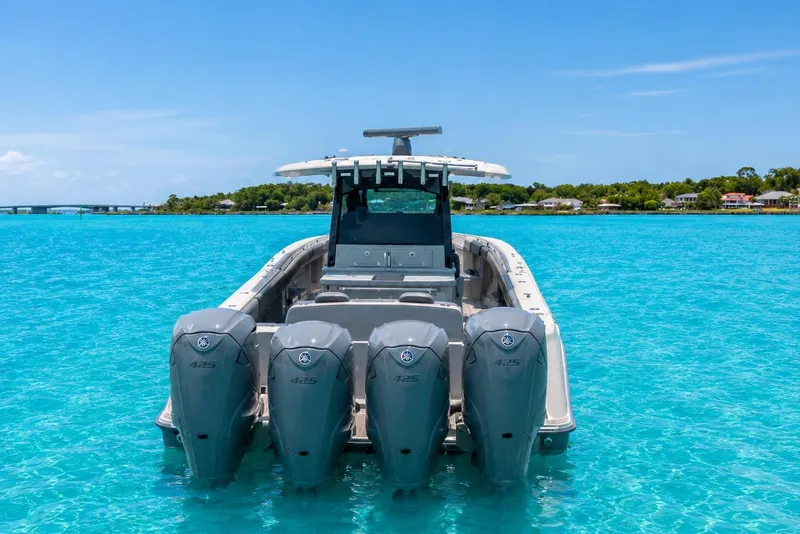 Slide: The Image of 2022 HCB 42 Lujo boat with four engines on turquoise water. - 4