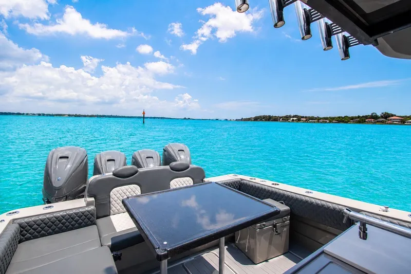 Slide: The Image of 2022 HCB 42 Lujo boat on turquoise water with clear sky. - 6