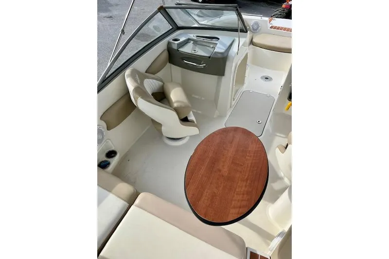 Slide: The Image of Interior of a 2019 Stingray 201 DS boat with seating and table. - 7