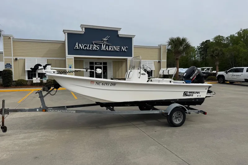 The Image of 2012 Carolina Skiff 1765 DLX boat on trailer at Anglers Marine NC dealership. - 1