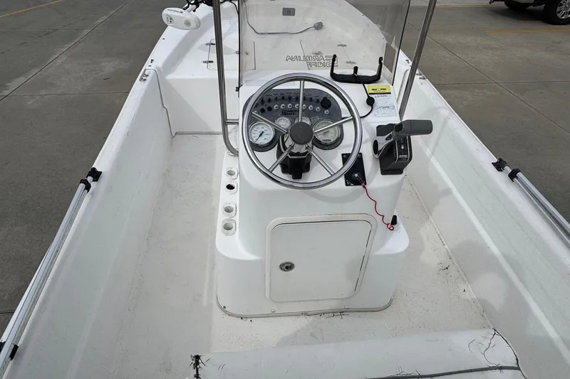 Slide: The Image of 2012 Carolina Skiff 1765 DLX boat interior with steering console and controls. - 10